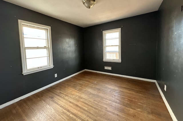 empty room with hardwood / wood-style floors