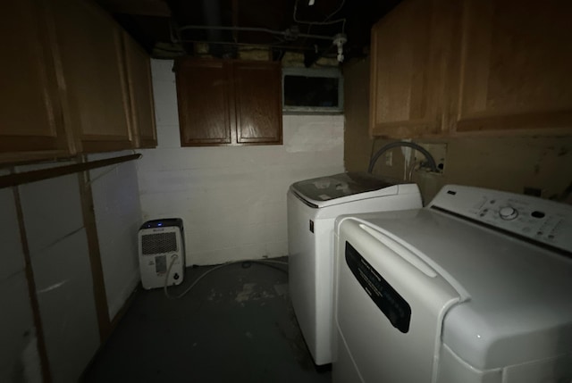 laundry area with cabinets and washing machine and dryer