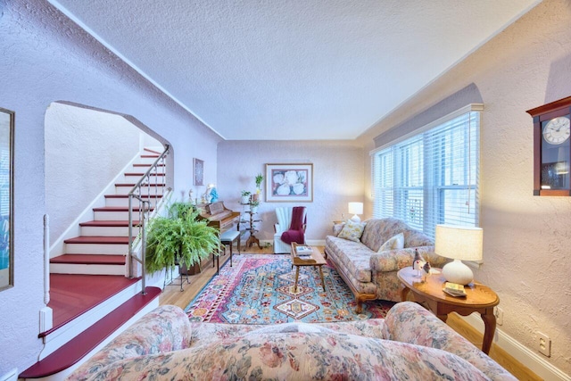 living room featuring a textured ceiling and wood-type flooring