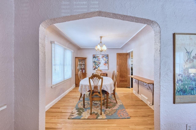 dining space featuring a chandelier and wood-type flooring