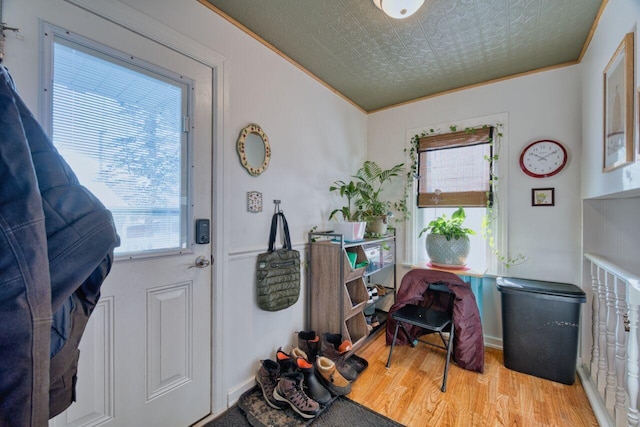 interior space with ornamental molding and light hardwood / wood-style flooring