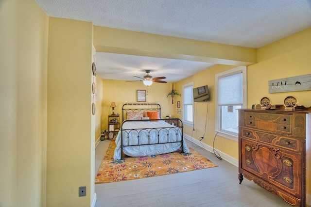 bedroom featuring a textured ceiling and ceiling fan