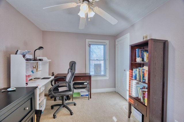 carpeted office space with ceiling fan