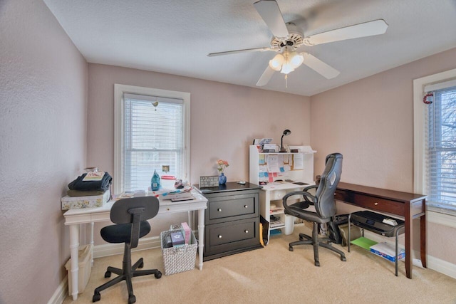 carpeted office featuring a healthy amount of sunlight and ceiling fan