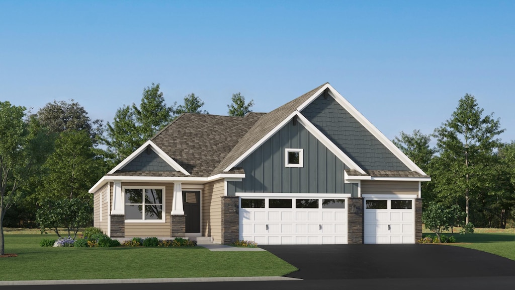 craftsman house with a front yard and a garage