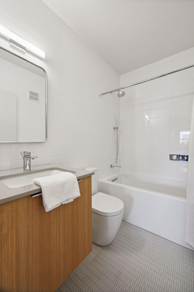 full bathroom featuring tile walls, tile patterned flooring, vanity, toilet, and shower / bath combo with shower curtain