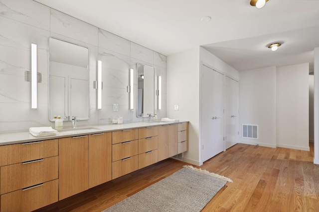 bathroom with vanity and hardwood / wood-style floors