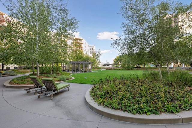 view of home's community with a pergola and a lawn