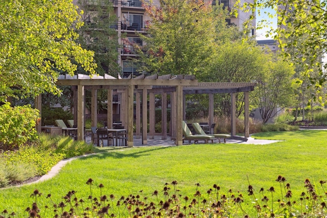 view of property's community with a pergola and a lawn