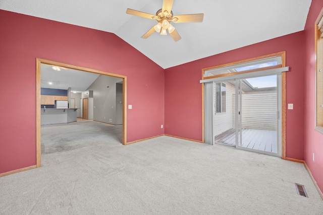 interior space with lofted ceiling, ceiling fan, and light carpet