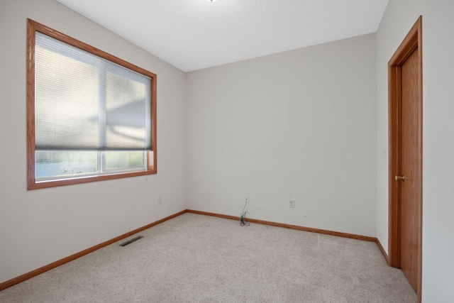 unfurnished room with light carpet