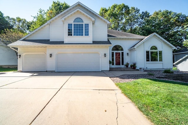 view of front of house featuring a front yard and a garage