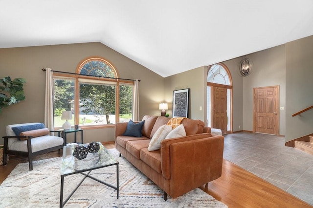 living room with light hardwood / wood-style floors and lofted ceiling