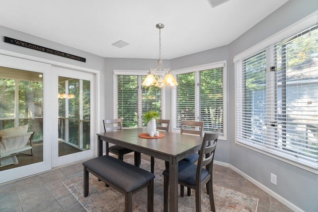 dining space featuring a healthy amount of sunlight and an inviting chandelier