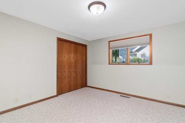 unfurnished bedroom with a closet and carpet floors