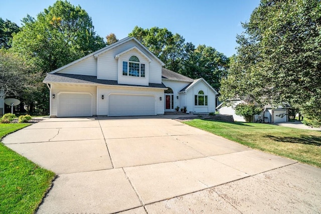 front facade featuring a front yard and a garage