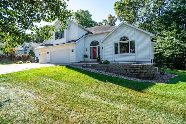 view of front of house featuring a garage and a front lawn