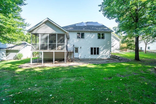 back of property with a sunroom, a yard, and a patio