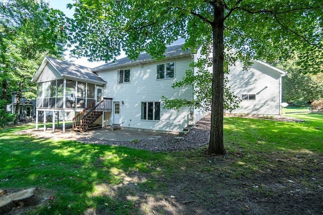 rear view of house with a yard, a patio area, and a sunroom