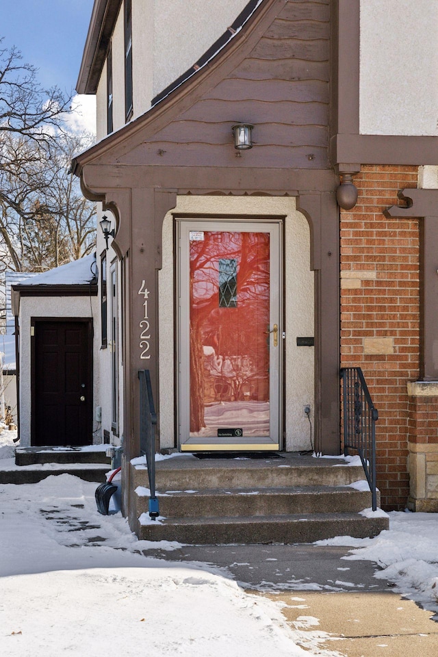 view of snow covered property entrance