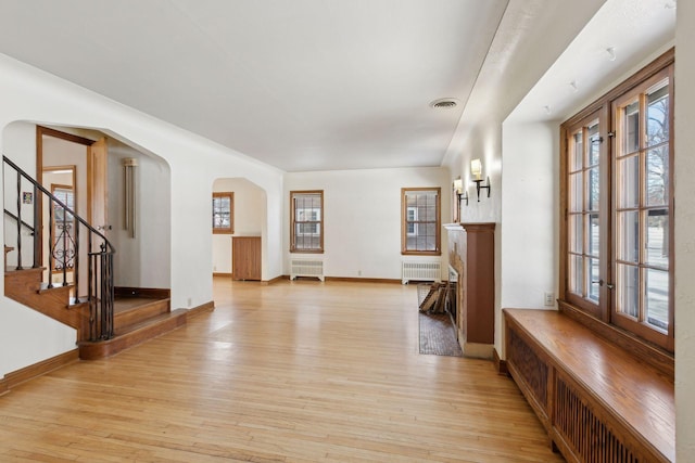 entrance foyer featuring radiator and light hardwood / wood-style floors