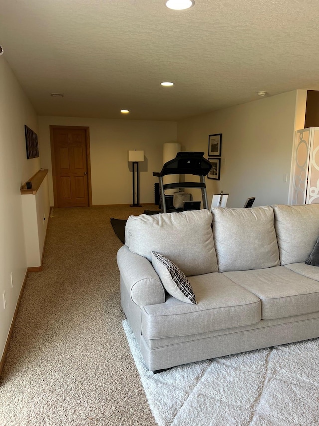 living area featuring a textured ceiling, recessed lighting, carpet flooring, and baseboards