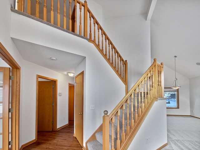 stairs featuring high vaulted ceiling, carpet flooring, and beam ceiling