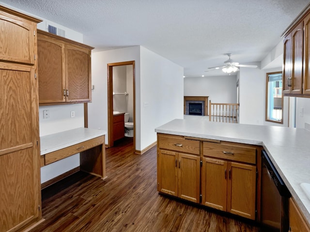 kitchen featuring a textured ceiling, ceiling fan, dishwasher, and dark hardwood / wood-style floors