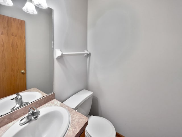 bathroom featuring toilet and vanity