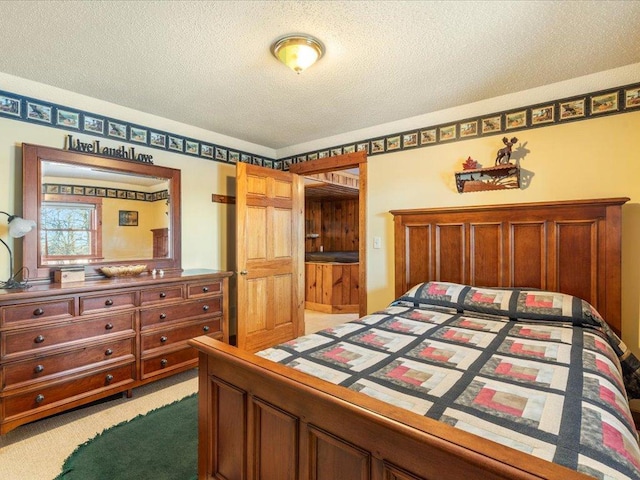 bedroom with light carpet and a textured ceiling