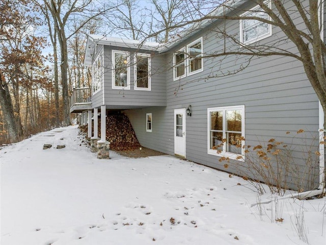 view of snow covered rear of property