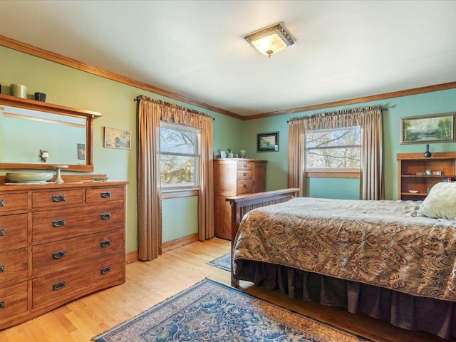 bedroom with light hardwood / wood-style flooring and ornamental molding