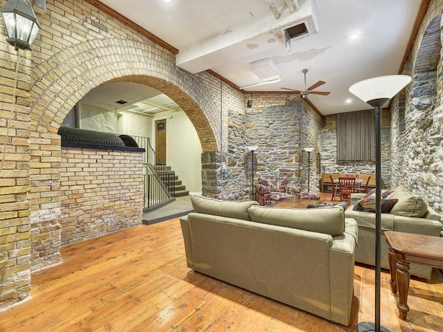 living room featuring ceiling fan, light hardwood / wood-style floors, and ornamental molding