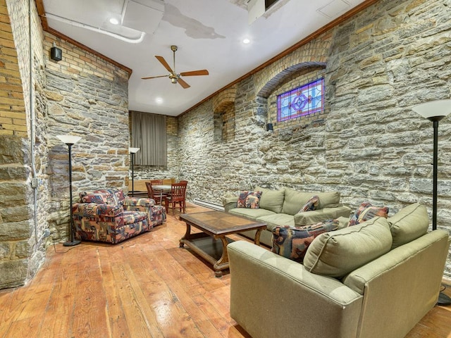 living room featuring ceiling fan, light hardwood / wood-style floors, and ornamental molding