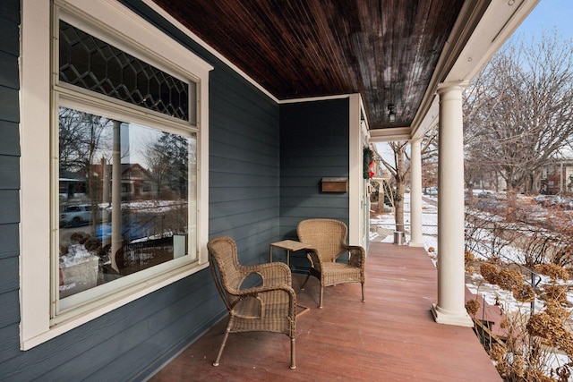 snow covered deck with covered porch