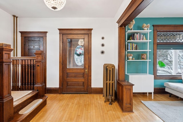 entrance foyer featuring radiator heating unit and light wood-type flooring