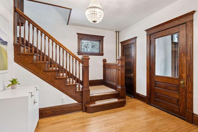 foyer featuring an inviting chandelier and light wood-type flooring