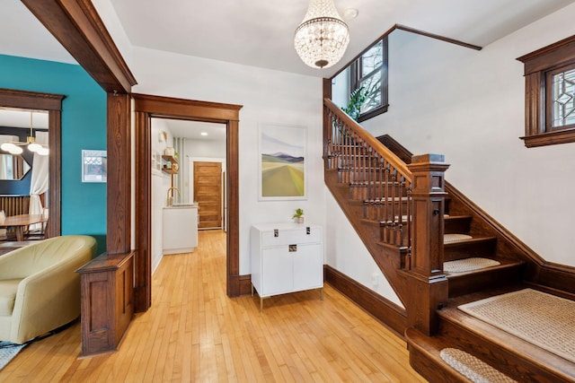 staircase featuring hardwood / wood-style flooring and a chandelier