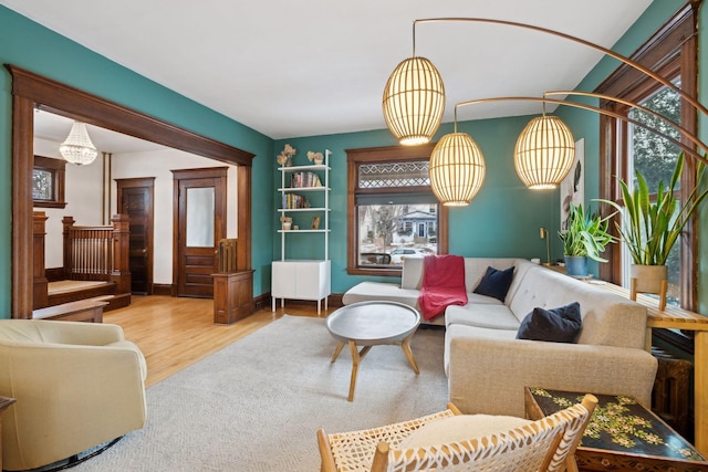 living room with an inviting chandelier and hardwood / wood-style flooring