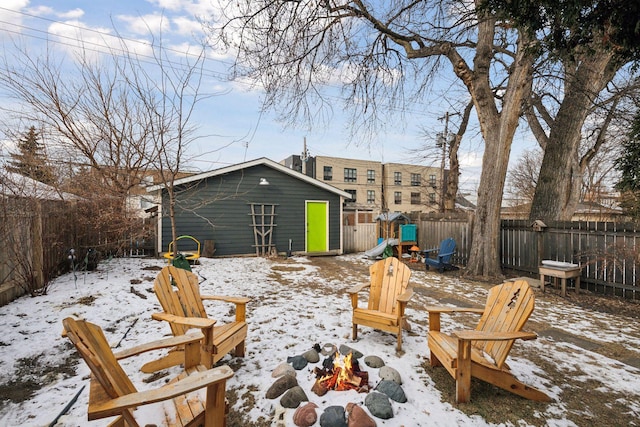 exterior space featuring an outbuilding, an outdoor fire pit, and a playground