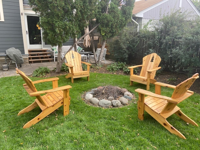 view of yard featuring an outdoor fire pit and a patio