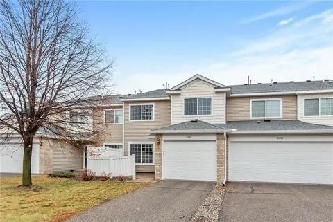 view of front of home with aphalt driveway, a front lawn, and an attached garage