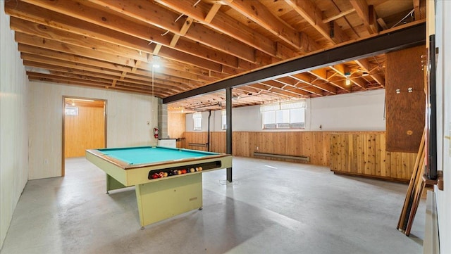 playroom featuring a baseboard radiator, pool table, concrete flooring, and wood walls