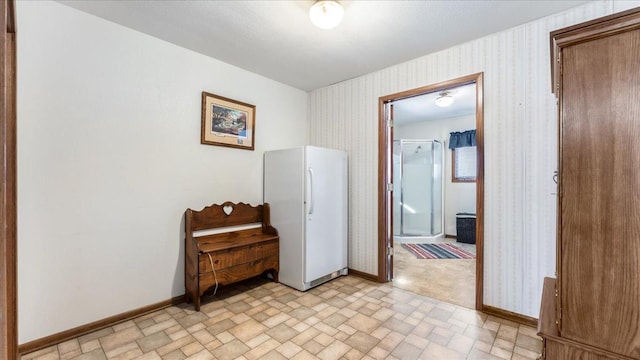 205 Ash St N, Sauk Centre, MN 56378 - bedroom featuring freestanding refrigerator, wallpapered walls, and baseboards