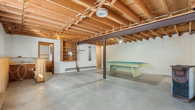 205 Ash St N, Sauk Centre, MN 56378 - unfinished basement featuring a baseboard heating unit, billiards table, and wooden walls