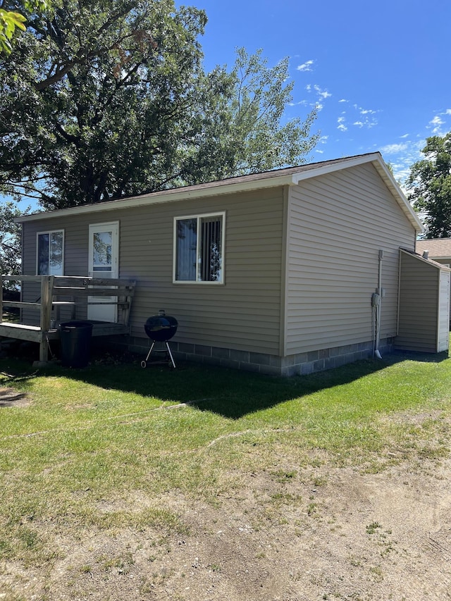 view of side of home with a yard