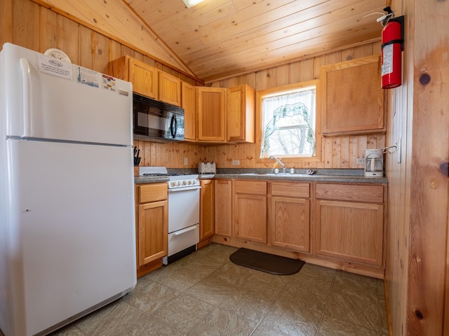 kitchen featuring wood walls, white appliances, and sink