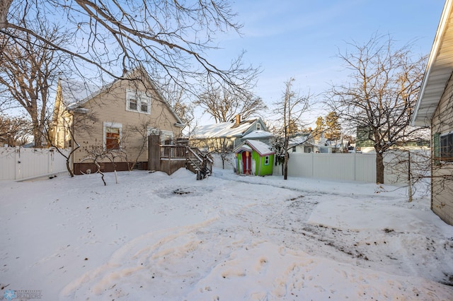 exterior space featuring a garage, fence, and a deck