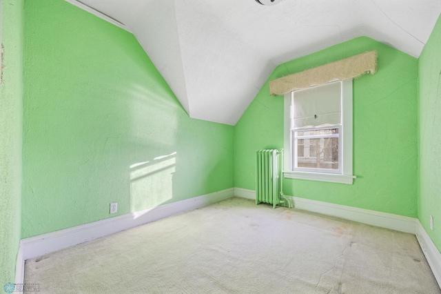 bonus room with radiator heating unit, lofted ceiling, and carpet flooring