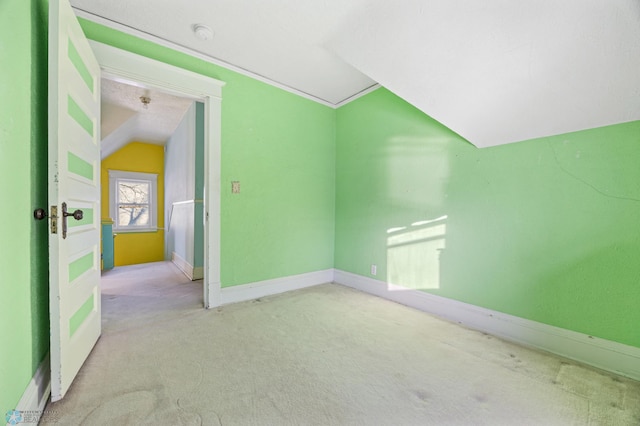 additional living space with light carpet, a textured ceiling, and vaulted ceiling